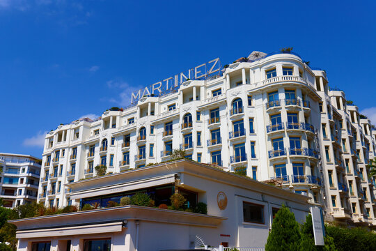 Art Deco facade of the Martinez Hotel with rooftop sign and blue-and-gold balconies on the Croisette, Cannes, French Riviera, France