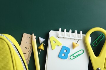 Different school stationery on blackboard, flat lay. Space for text © New Africa
