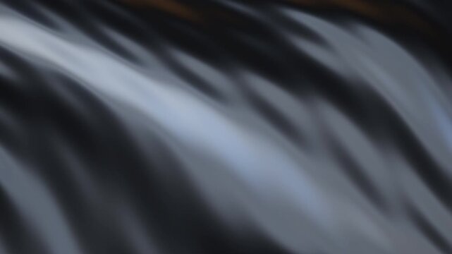 Abstract flowing silver gray and black wavy streaks with soft white and pale blue highlights and subtle brown bands, slowly drifting upward in a blurred, silky, liquid motion background