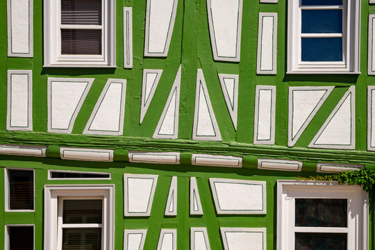 Architectural detail of a striking green and white half-timbered house in the historic old town of Idstein, Hesse, Germany.