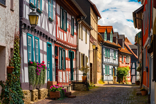 Historic Kreuzgasse in Idstein, Hesse, with colorful half-timbered houses, cobblestones and flowers in the picturesque old town on a sunny summer day.