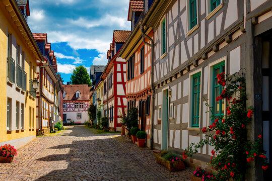 Picturesque Kreuzgasse in Idstein, Hesse, with colorful half-timbered houses, cobblestones and blooming roses in the historic old town.