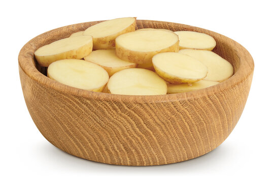 young potato slices in wooden bowl isolated on white background. Harvest new