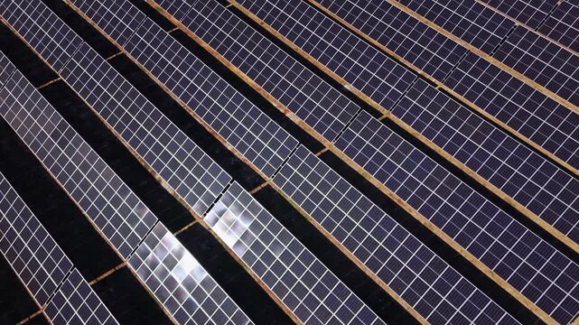 Aerial view of rows of photovoltaic solar panels installed in a large field in Temerin, Vojvodina, Serbia.