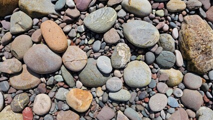 Natural Scottish beach pebbles and gravel background texture of multi sized smooth sea stones photo © LadyLensArt 