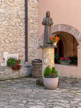 A statue of St. Francis holding the Order's Rule, located in the courtyard of the Franciscan Sanctuary at Fonte Colombo, Italy