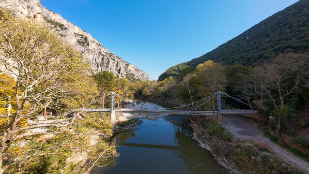 Aerial view of the damaged Agia Paraskevi pedestrian suspension bridge in Tempi Valley, Greece, after storm Daniel 
