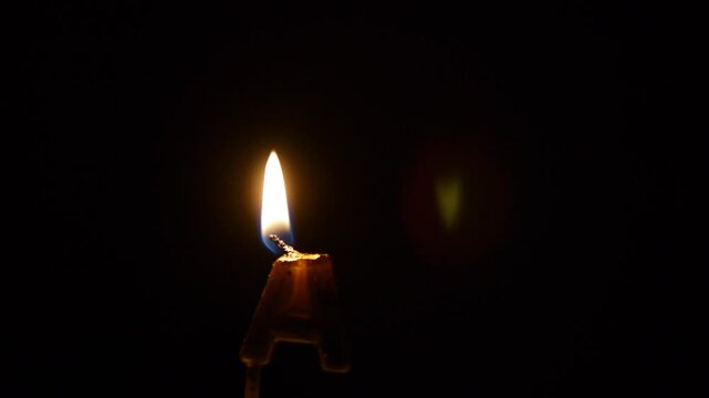 Melting Wax Alphabet Letter A Candle Fading and Extinguishing on Black Background for Cinematic Title Sequence or Moody Typography