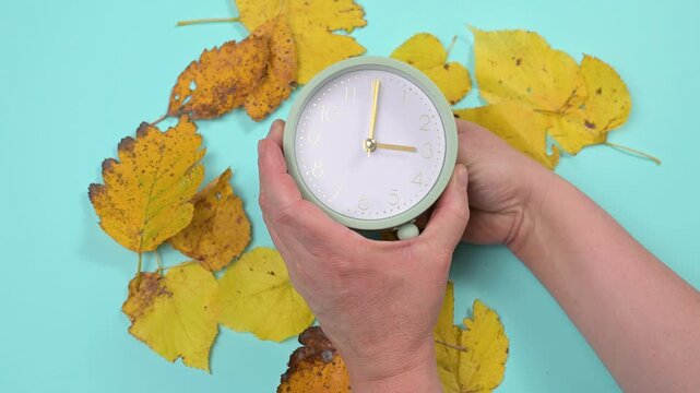 End of daylight saving time in autumn, winter time changeover, alarm clock fall back switch, colorful foliage