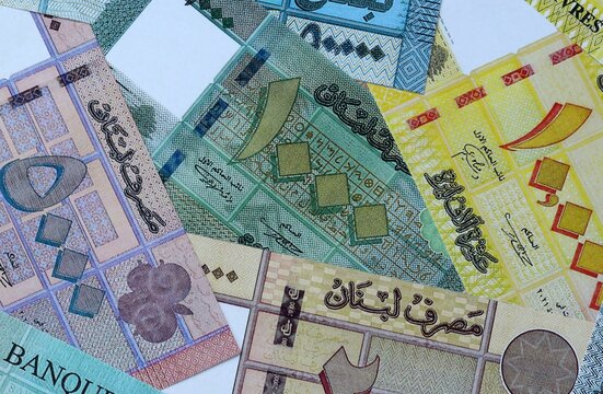 Lebanese pound money bills in pile on table. Lebanon LBP currency cash close up