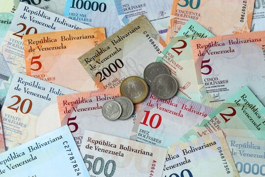Venezuelan bolivar money banknotes and coins on table. Venezuela cash bills of VES currency