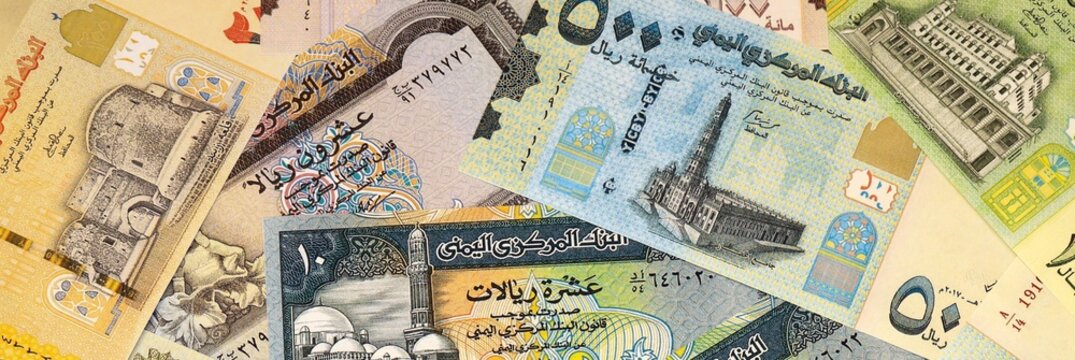 Yemeni rial money bills in pile on table. Yemen YER currency cash close up