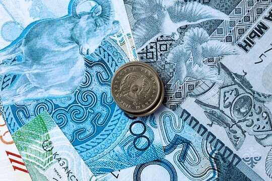 Kazakhstani tenge money banknotes and coins on table. Kazakhstan cash bills of KZT currency