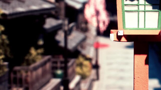 A lantern is placed on a street in a city. Old buildings can be seen in the background. The scene is bright with a clear view of the surroundings. This is likely a popular area for visitors.