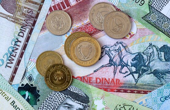 Bahraini dinar money banknotes and coins on table. Bahrain cash bills of BHD currency