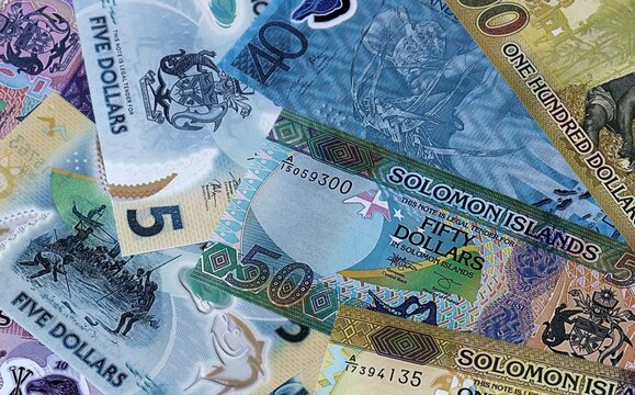 Solomon Islands dollar money bills in pile. Big amount of Solomon Islands SBD currency cash close up