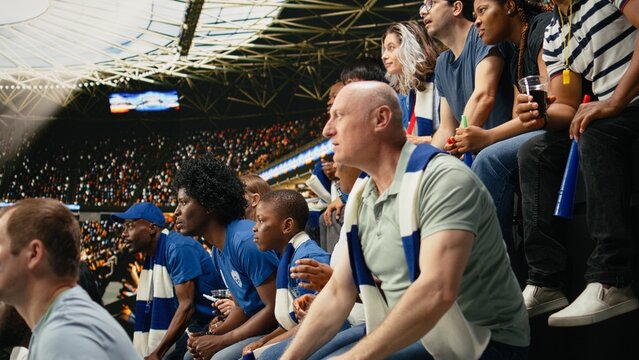 Tense blue supporters reacting to close call at live soccer match