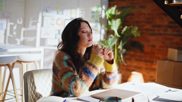 Thoughtful business woman clasped hands thinking desk. Designer dreaming office.