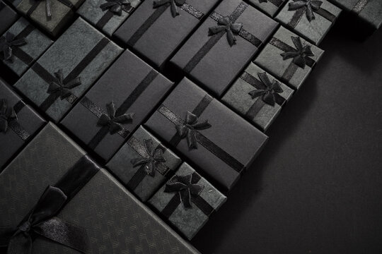 Black gift boxes with bows creating a luxury pattern