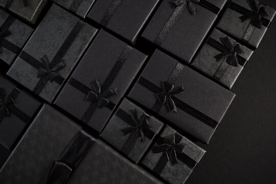Black gift boxes with ribbon bows for luxury celebration