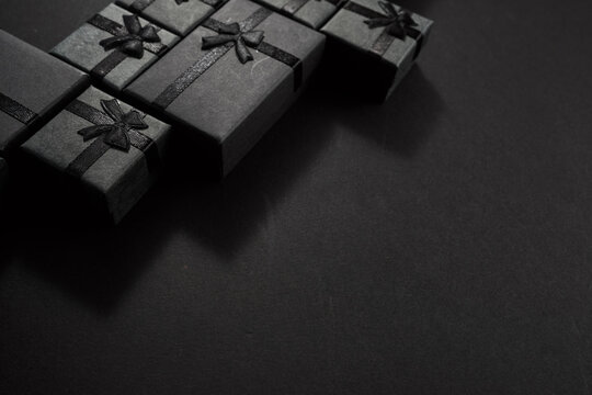 Black gift boxes with bows on dark background