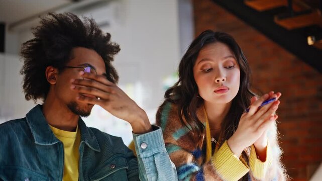 Multiethnic coworkers brainstorming office. Tired man, woman explaining idea.