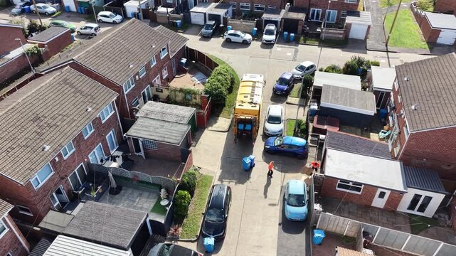 aerial view of refuse collecting lorry collecting domestic rubbish from homes using the wheelie bin system, City waste manage and recycling  