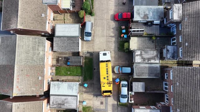 aerial view of refuse collecting lorry collecting domestic rubbish from homes using the wheelie bin system, City waste manage and recycling  