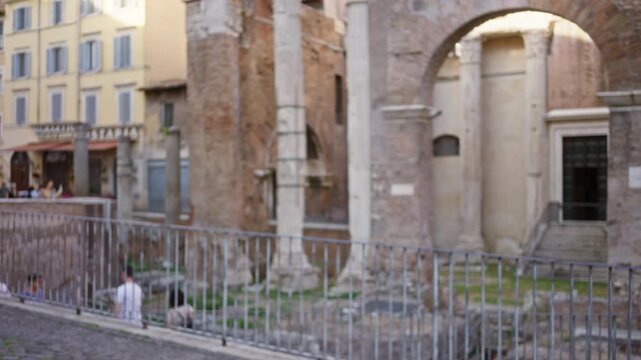 Roman street scene in soft blurred bokeh with shallow depth, ancient stone columns and metal railing rendered out of focus outdoor; background backplate copyspace calm.