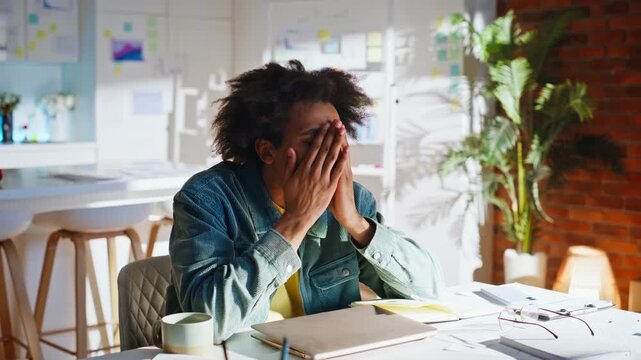 Designer covering face hands home office. Young man despair project deadline.