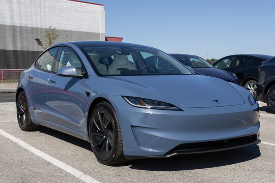 Tesla Model 3 Electric Sport Sedan at a dealership. Tesla offers the Model 3 with up to 321 miles driving range. MY:2026