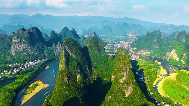 Aerial view of dramatic karst mountain peaks surrounding the Li River near Xianggong Mountain in Guilin during daytime.