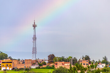Obraz premium Rainbow over a town on a rainy day, in Monte Escobedo, Zacatecas