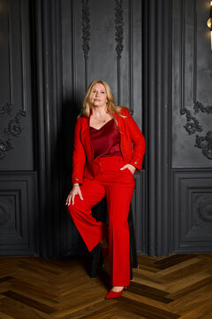 Stylish mature woman strikes commanding pose in luxurious environment