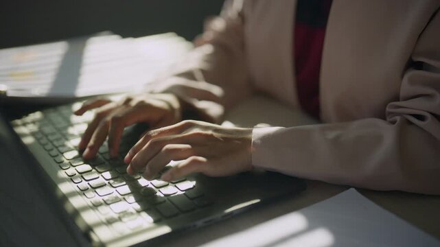 Close-up hands of a professional typing on a computer keyboard, representing business administration, office tasks, document preparation, productivity, digital technology, and corporate work.