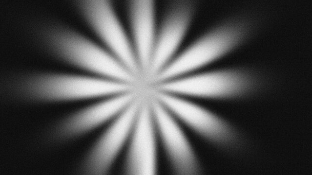 Abstract retro radial sunburst with monochrome grain texture. Dark starburst background, glowing light rays, vintage cinematic overlay.