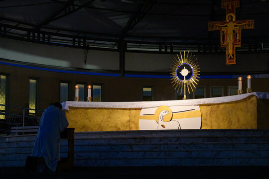 Priest kneeling in prayer before the Blessed Sacrament in Medjugorje, Bosnia and Herzegovina.