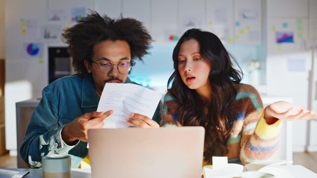 Startup entrepreneur discussing document laptop home office. Multiethnic team.