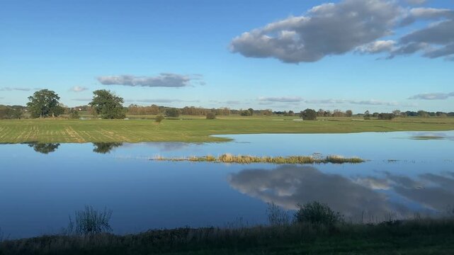 Silent flooded meadows are reflected, clouds and meadows on the horizon, Langenfeld, D&ouml;mitz, Elbe, Wendland, Lower Saxony, Germany