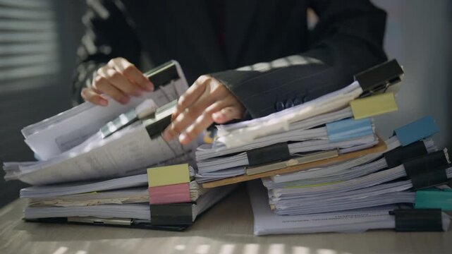 Legal professional reviewing case files and documents at an office desk, representing legal research, case preparation, evidence review, documentation, litigation, and professional law services.