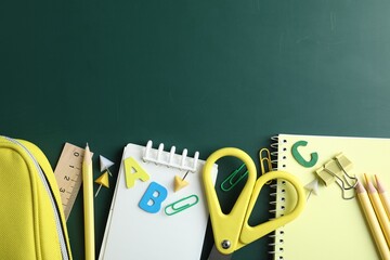 Different school stationery on blackboard, flat lay. Space for text © New Africa