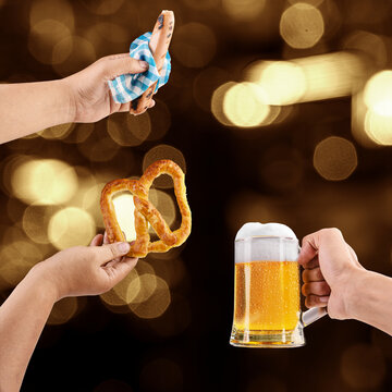 Composite image showing a hand holding a sausage, a hand holding a pretzel, and a hand holding a beer mug against a festive bokeh background. Bavarian Oktoberfest Festival