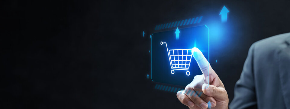 Businessman touching a virtual shopping cart icon on a futuristic digital display, symbol e-commerce, online shopping, and digital marketing. Concept of Online shopping, E-commerce and Modern Retail