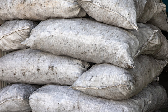 Stacked Dirty White Woven Burlap Sandbags &ndash; Industrial Storage Background Texture