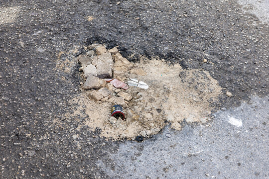 Unprofessional Temporary Pothole Repair with Sand and Rubble &ndash; Poor Road Maintenance
