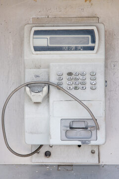 Old Dirty Worn Public Payphone with Missing Handset Speaker &ndash; Vandalized Abandoned Street Telephone