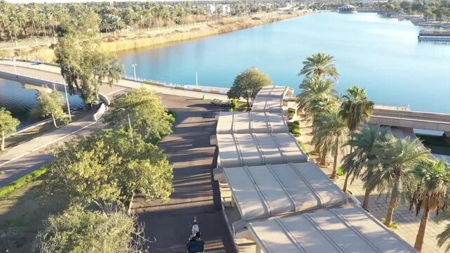 Aerial view of the lakes and palm-lined paths of Baghdad Island tourist park, Iraq