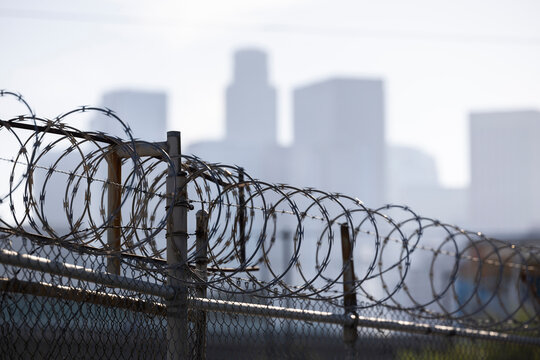 Barbed wire frames the in downtown skyline in Los Angeles, California, USA.