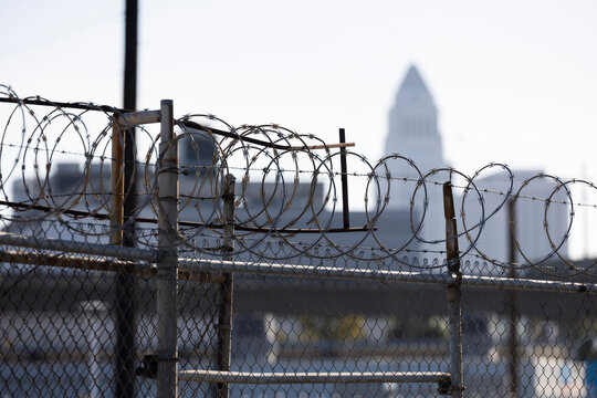 Barbed wire frames City Hall in downtown Los Angeles, California, USA.