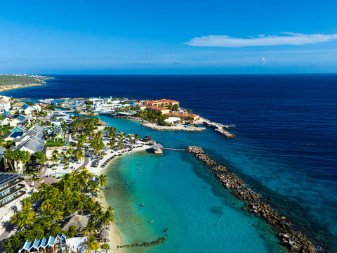Mambo Beach with turquoise water, palm trees and white sand in Curacao, Caribbean
